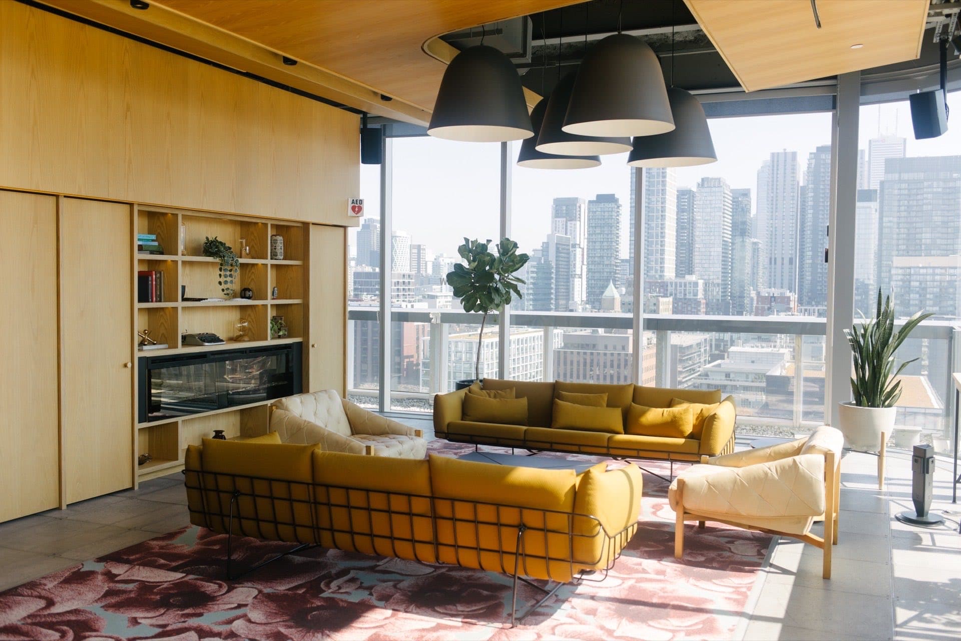 Custom office plant design by Benji's in a Toronto lounge with skyline views